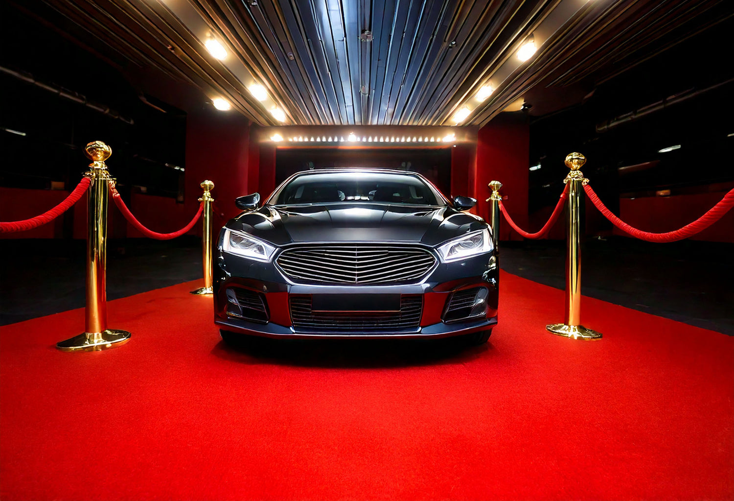 VIP car parking space with a black sports car on a red carpet with rope stands at the sides